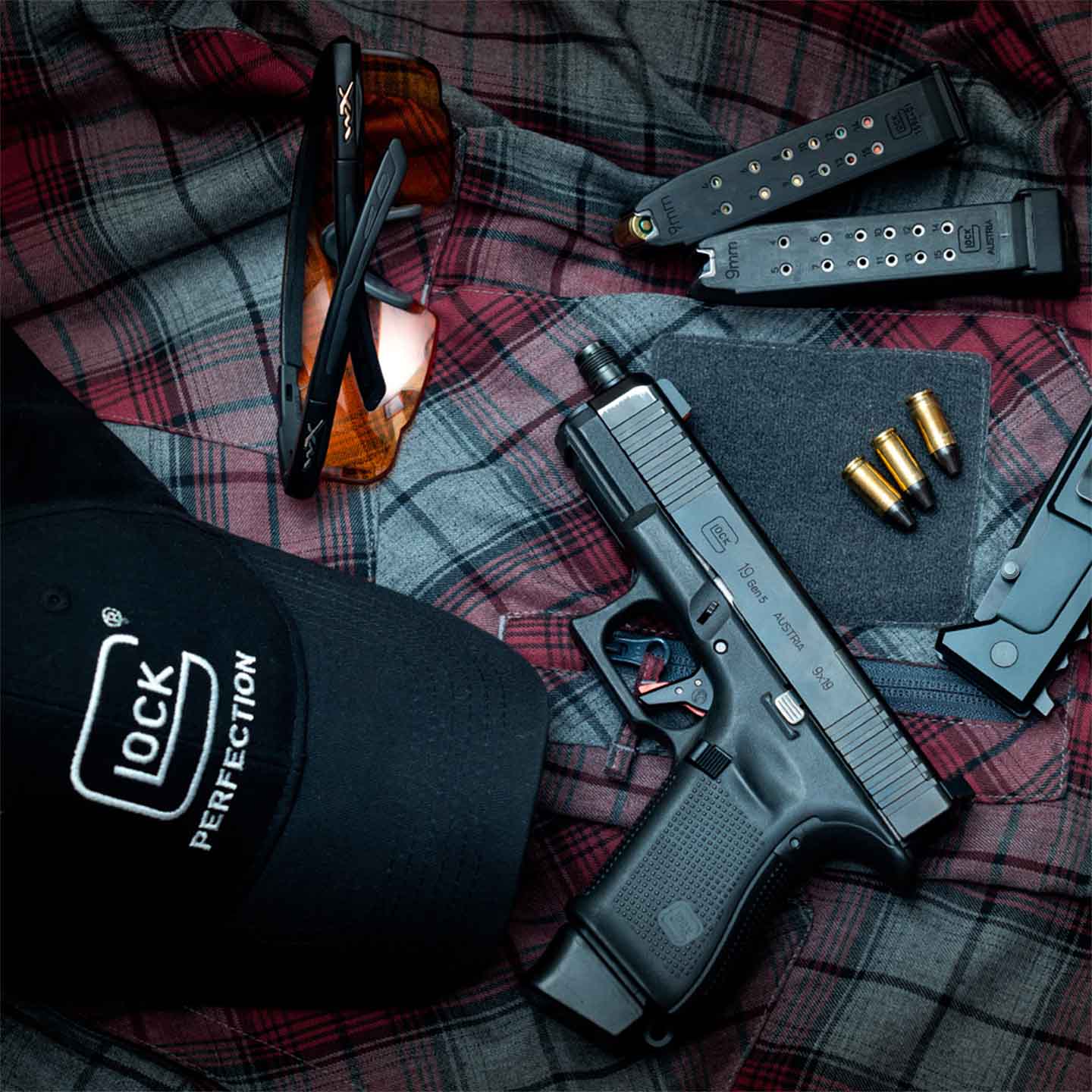 Glock pistol, ammo, safety glasses and Glock hat