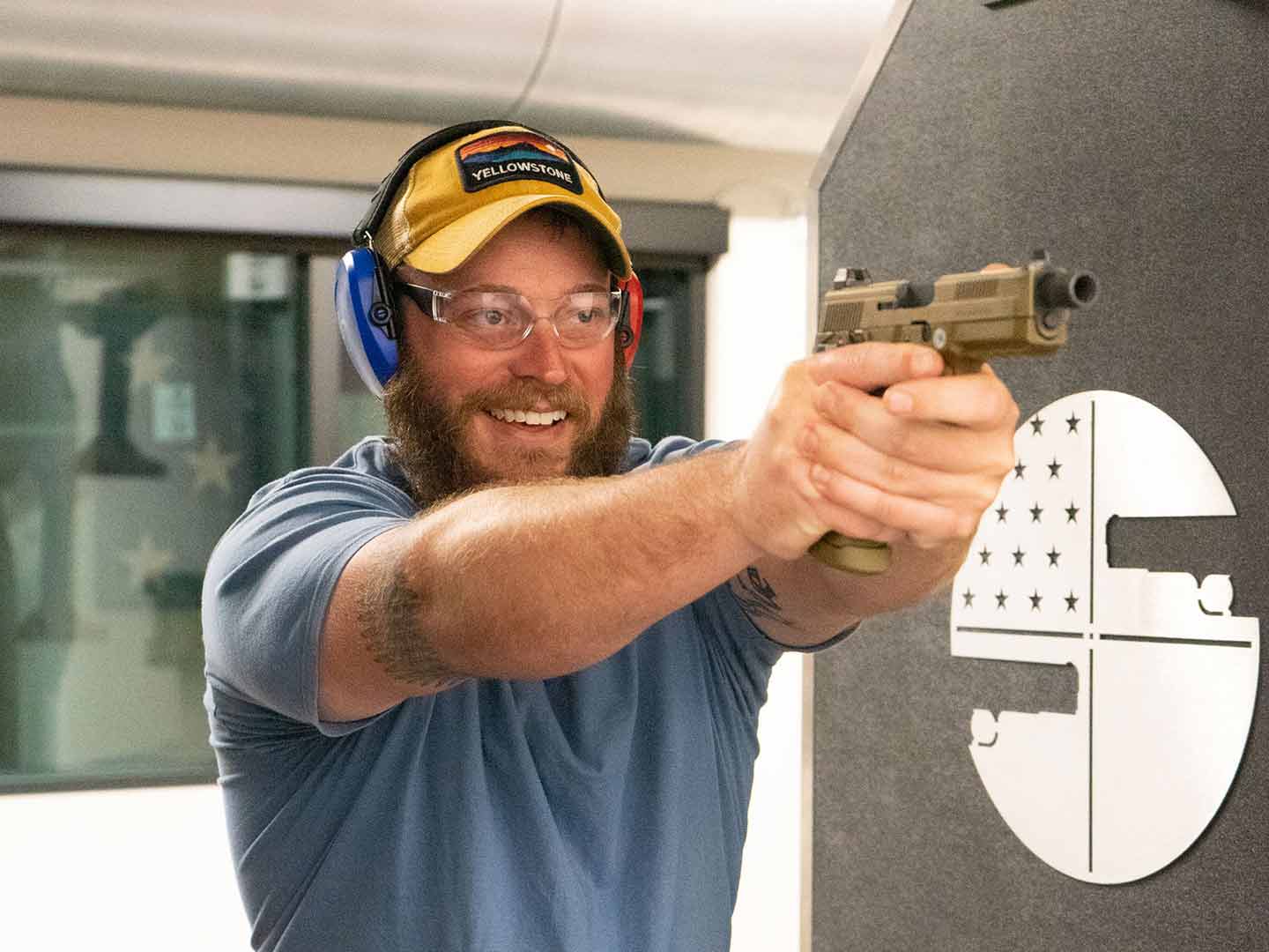 https://shootersworld.com/wp-content/uploads/4_3-Guy-in-Yellow-Hat-Smiling-Shooting-Handgun.jpg